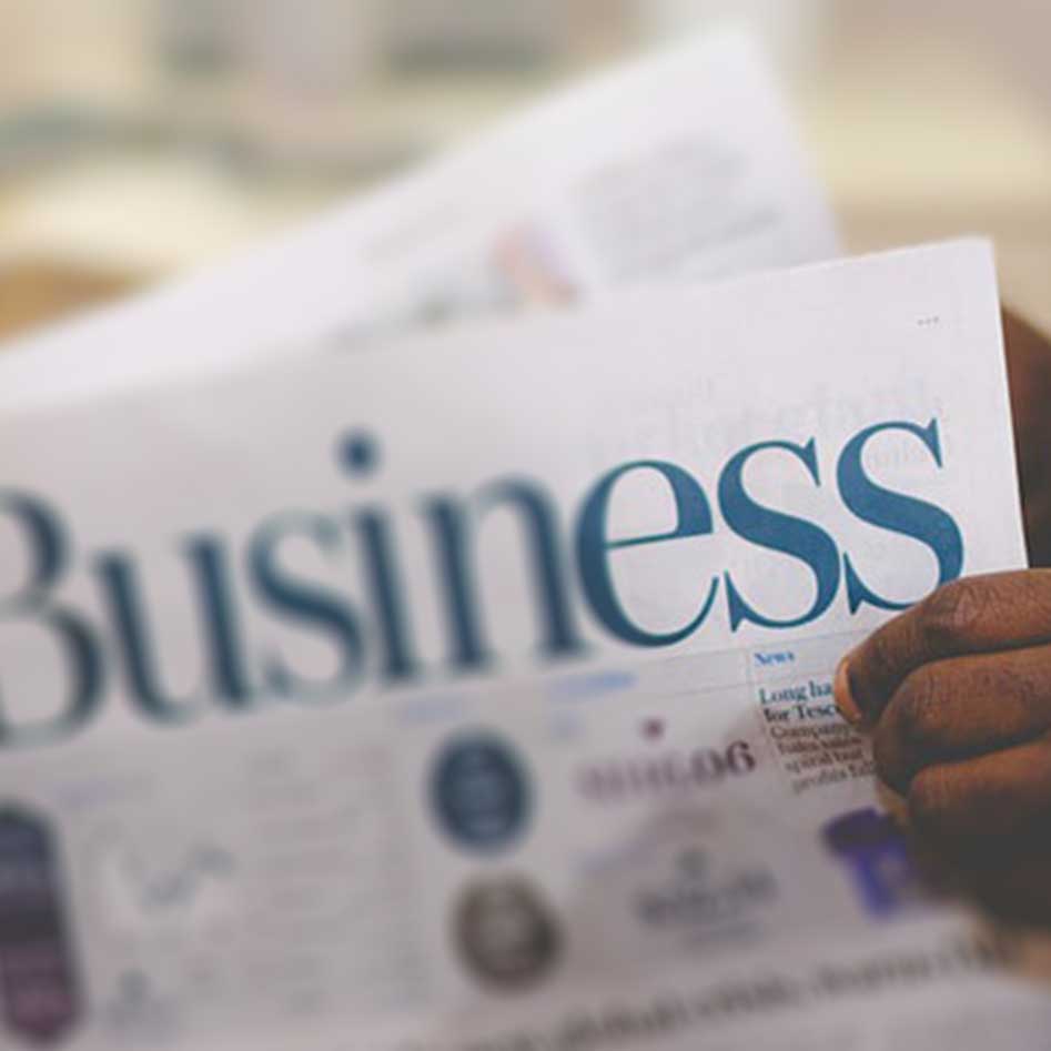 Customer holding a business newspaper 