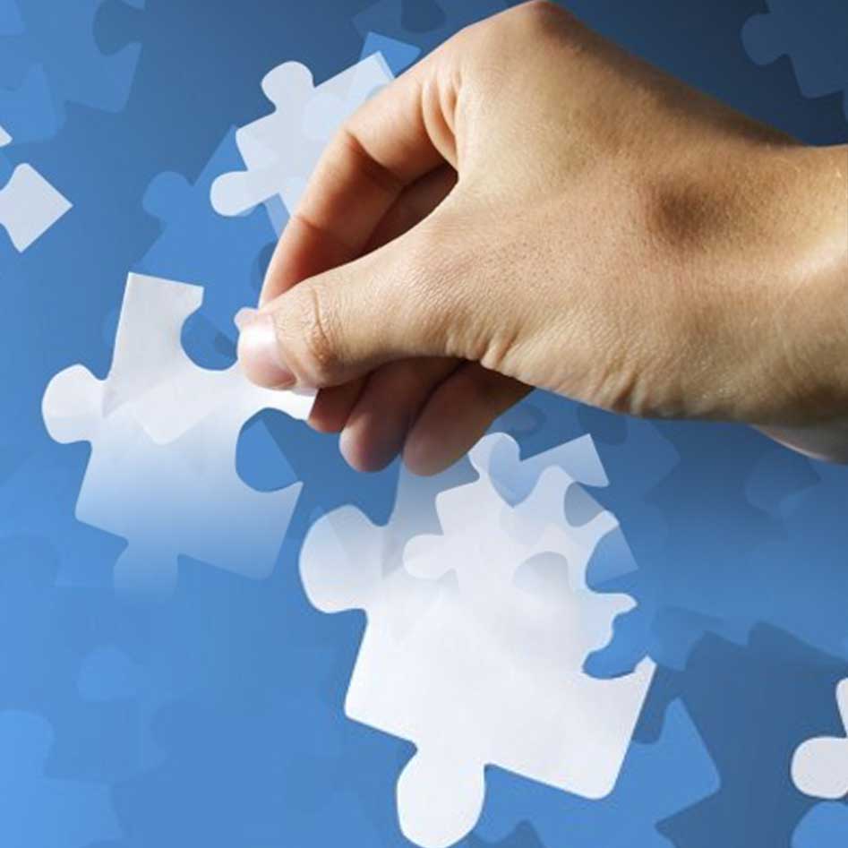 Hand Holding Puzzle Pieces on Blue Background